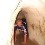 Contingue crawling in the (double:tourist size) VC tunnel at Cu Chi